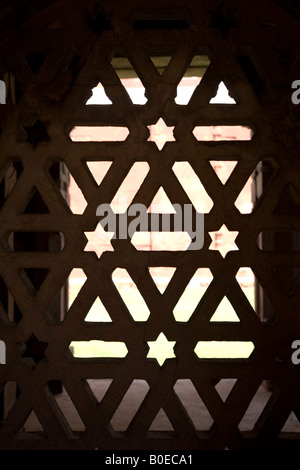 Decorative Muslim style Jali work in the Tughluqabad Fortress of Delhi, India. Jali work was frequently used to close portals. Stock Photo