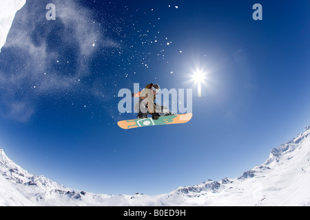 Snowboarder Clark Murray spins over the French Alps Stock Photo