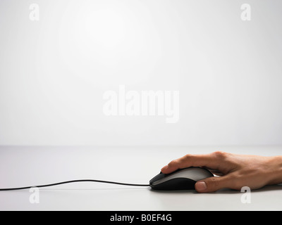 Woman using a computer mouse Stock Photo
