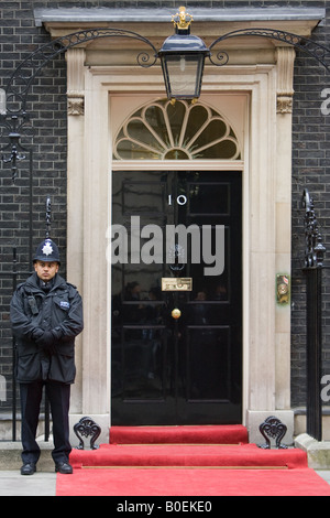 Armed policeman guards Number 10 Downing Street official home of the British Prime Minister London UK Stock Photo