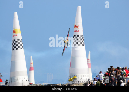 Crowd watched airplane going through obstacle course at Red Bull air race during San Francisco Fleet week Stock Photo