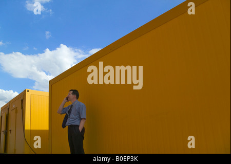 Businessman using cellular phone outside building Warsaw Poland Stock Photo
