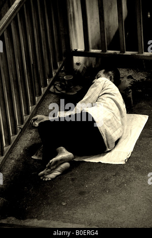 homeless man sleeping rough in bangkok, thailand Stock Photo