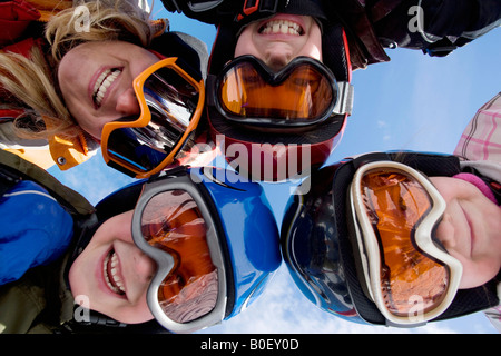 Mother with children wearing ski helmets Stock Photo