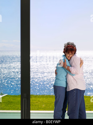 Mature man and woman embracing outside Stock Photo