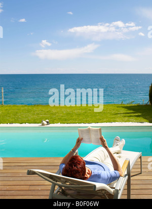 Mature woman relaxing on a deck chair Stock Photo