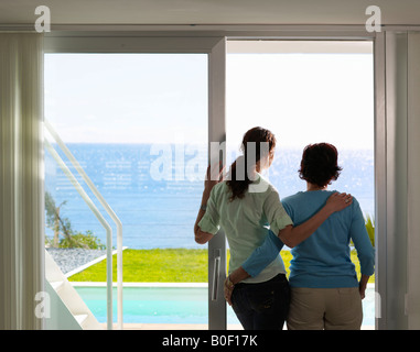 Mother and daughter looking out to sea Stock Photo