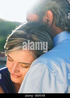 Mature man embracing mature woman Stock Photo