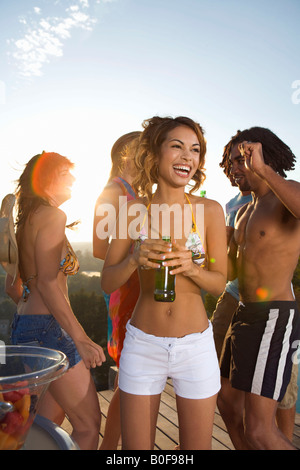 Men and women dancing on terrace Stock Photo