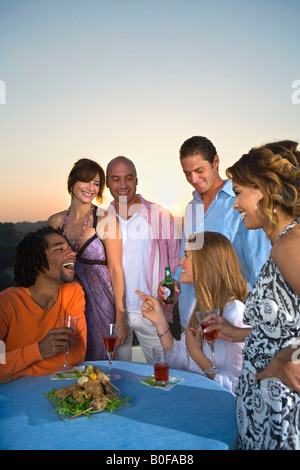 Young people having dinner at sunset