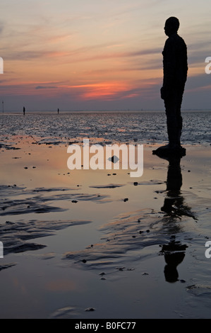 Antony Gormley's Another Place Statues at Sunset on Crosby Beach, Crosby, Merseyside, England, UK Stock Photo