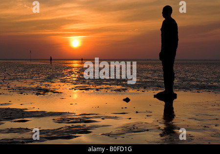 Antony Gormley's Another Place Statues at Sunset on Crosby Beach, Crosby, Merseyside, England, UK Stock Photo