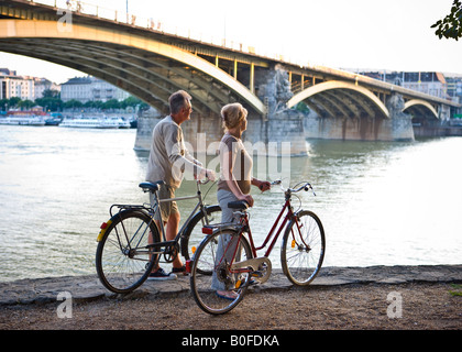 Couple by river with bikes Stock Photo