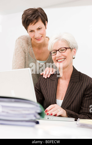 Two women working together at a pc Stock Photo