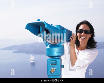 Woman looking through spyglasses Stock Photo