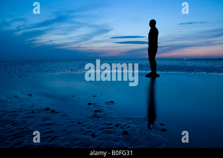 Antony Gormley's Another Place Statues at Twilight on Crosby Beach, Crosby, Merseyside, England, UK Stock Photo