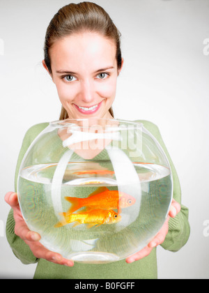 Woman handing a goldfish aquarium Stock Photo