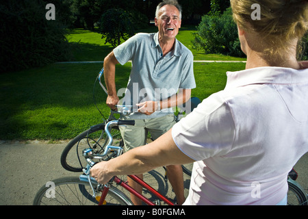Couple with bikes talking Stock Photo