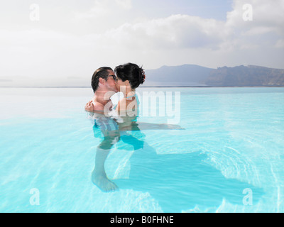 Couple kissing in swimming pool Stock Photo