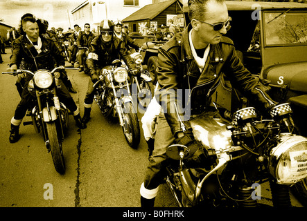 Greaser 1950s rockers gang on British classic BSA Norton motorcycles at Goodwood Revival Stock Photo