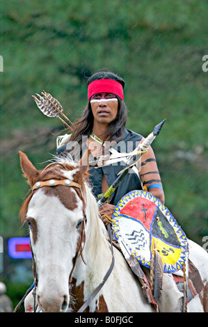 A Native American Indian decorated and dressed in traditional warrior ...