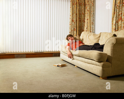 Man sleeping on sofa Stock Photo