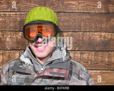 Young man in goggles and snow gear Stock Photo