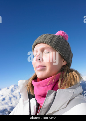 Young woman enjoying sun at mountains Stock Photo