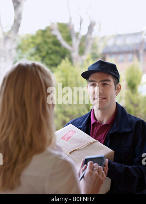 Courier and recipient in doorway Stock Photo