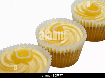 Lemon buns with butter icing and sugared lemon. Stock Photo