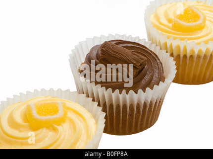 Lemon buns with butter icing and sugared lemon and a chocolate bun topped with a flake. Stock Photo