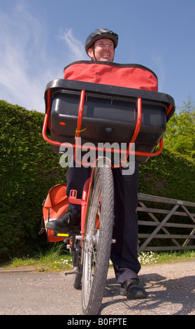 A Postman On His Round in the Uk in Spring Stock Photo