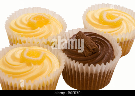 Lemon buns with butter icing and sugared lemon and a chocolate bun topped with a flake. Stock Photo