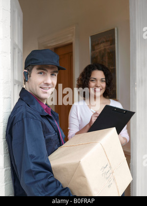 Courier delivering parcel to woman Stock Photo