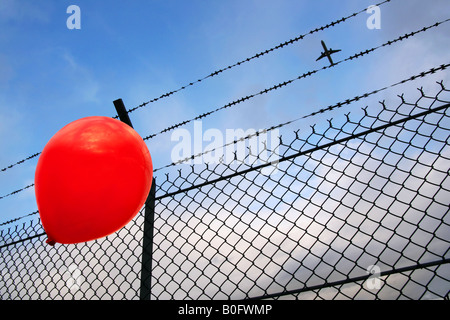 A red balloon in danger Stock Photo