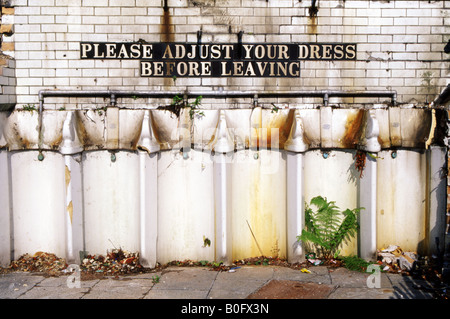 old style public male urinals with amusing tiled sign awaiting demolition portsmouth england uk Stock Photo