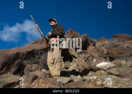 North America, United States, Man Upland Bird Hunting for Alectoris Chukar in the South Eastern Oregon Owyhee River Canyon. MR Stock Photo