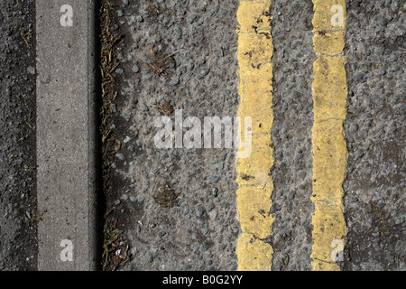 Double yellow lines on British road Stock Photo