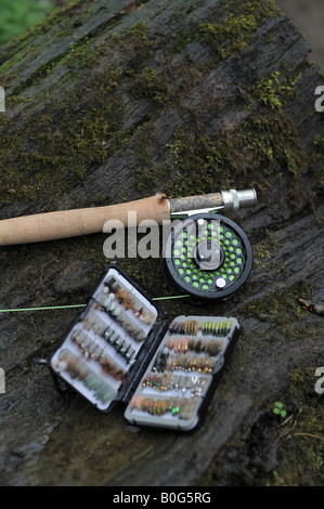 A fly fishing set of tackle, with rod, reel and a box of assorted flies dry and wet for fishing. Stock Photo