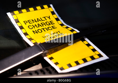 Yellow Parking ticket on car screen under windscreen wiper blade. Stock Photo