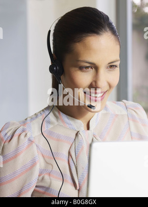 Young woman wearing headset Stock Photo