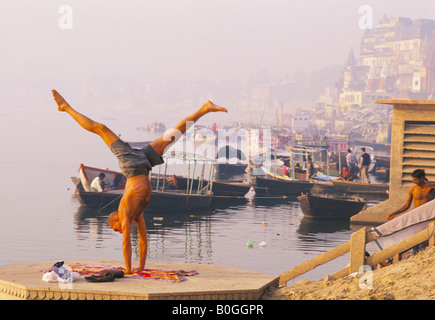 Man practicing yoga by the River Ganges, Varanasi, India. Stock Photo