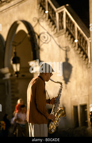 A saxophone player busking on Rynek Gl+¦wny (the Main Market Square), Krakow, Poland. Stock Photo