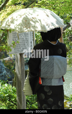 japanese woman in kimono reading japanese script Stock Photo