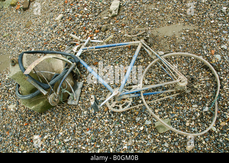 A wrecked bicycle locked to a post on the pavement Stock Photo - Alamy