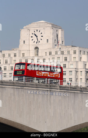 London England a red double decker bus passes over Waterloo Bridge with Shell Mex House behind Stock Photo
