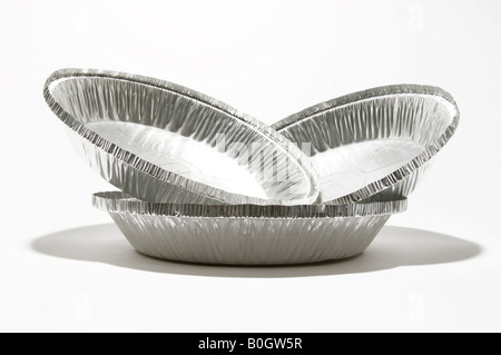 Three stacked aluminum metal containers on a white background. Stock Photo