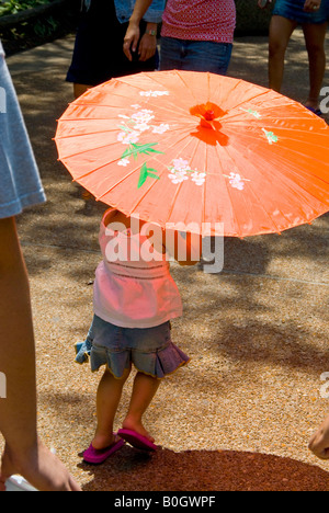 Little Girl with Umbrella and flip flops Stock Photo