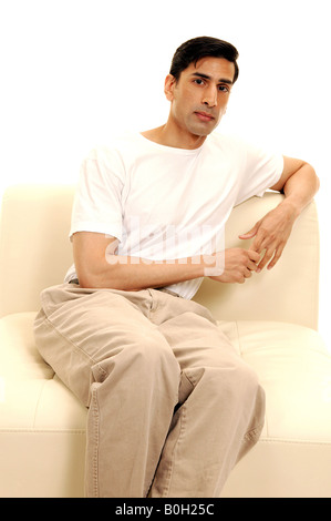 Man Sitting in Chair Stock Photo