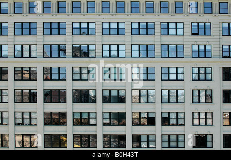 rows of square office building windows filling the frame in a symmetrical image Stock Photo